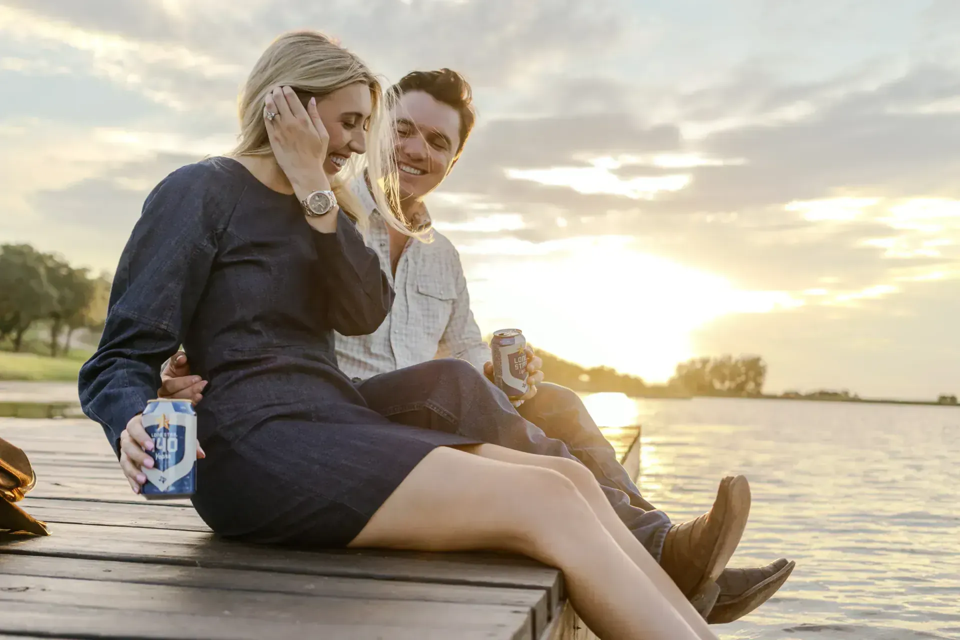 Couple on dock at sunset during engagement session